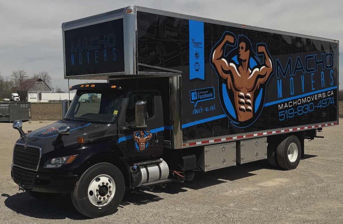 Macho Movers team member carrying a rug and giving a thumbs up